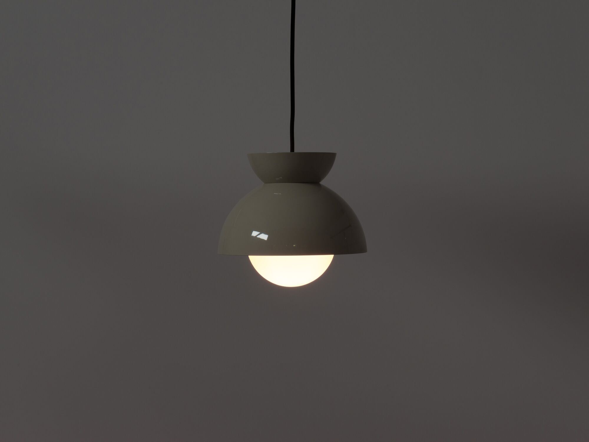 Modern grey pendant lamp with light on side view